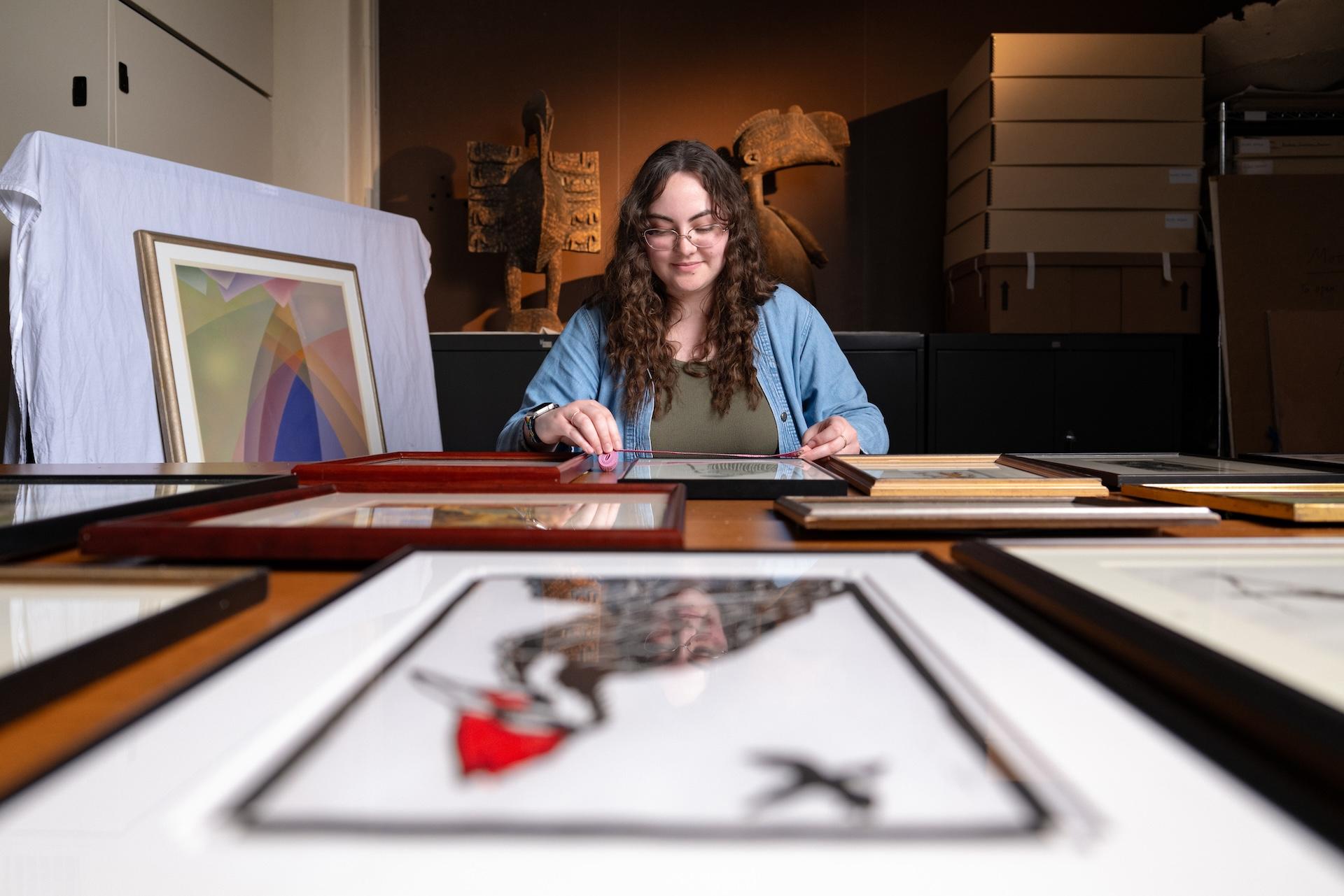 Berea College student taking inventory of art in the Doris Ulmann Galleries.